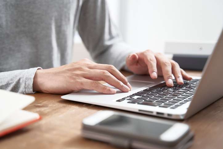 male businessman working from home in plain clothes
